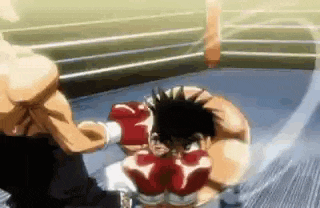 two men are boxing in a boxing ring .
