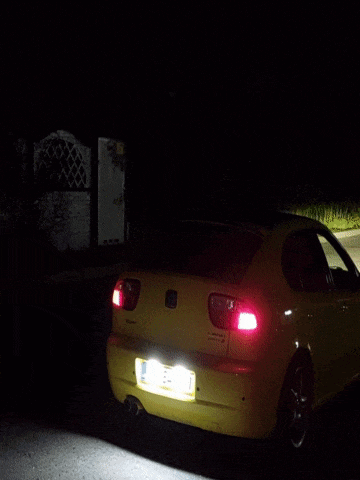 a yellow car with a license plate that says ' tc ' on it