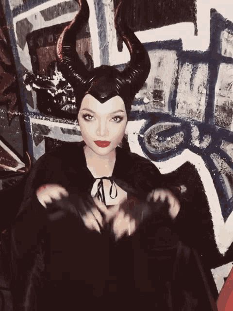 a woman in a maleficent costume with horns on her head