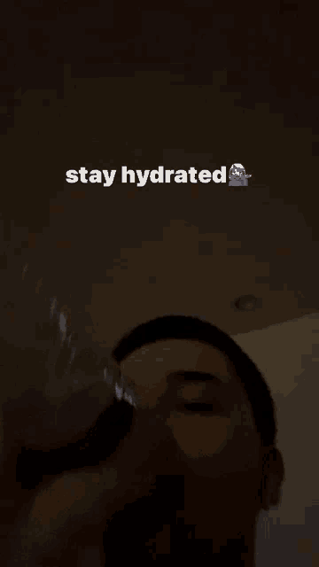 a man drinking a glass of water with the words stay hydrated below him
