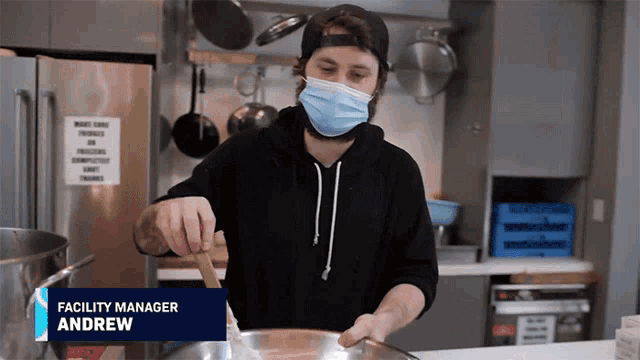 a man wearing a face mask is cooking in a kitchen with the name andrew on the bottom