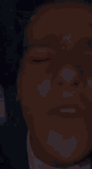 a close up of a person 's face with their eyes closed and nose piercings .