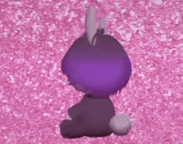 a stuffed animal with purple hair is sitting on a pink surface .