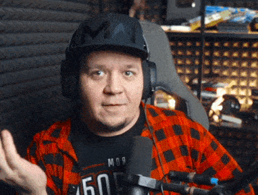 a man wearing headphones and a hat has the letter m on it