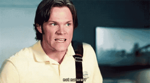 a man wearing a yellow polo shirt is asking " not natural "