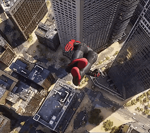 a person in a spiderman costume is flying through the air in a city