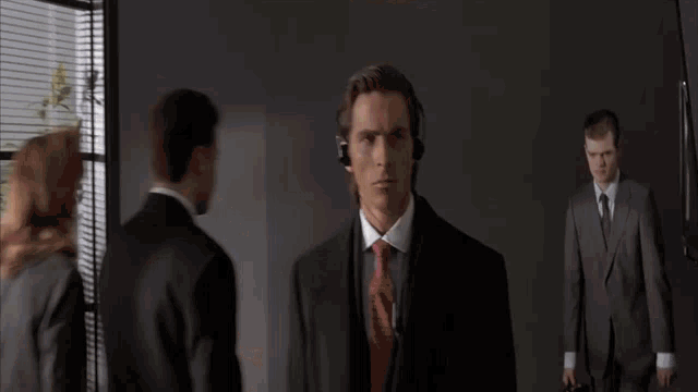 a man in a suit and tie with headphones on his head