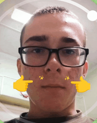 a young man wearing glasses has a yellow hand pointing at his face