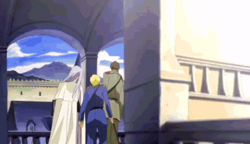 a group of people are walking down a balcony with a view of mountains in the background