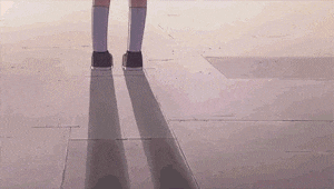 a person is walking on a tiled floor with their shadow cast on the floor .