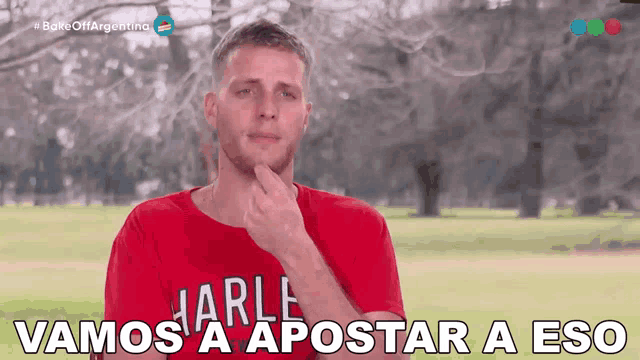 a man wearing a red shirt that says marle on it