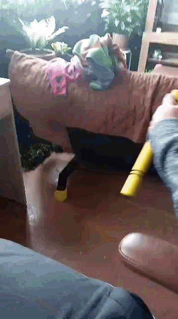 a person is sitting on a couch and holding a yellow object