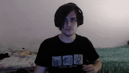 a man wearing headphones and a athens greece t-shirt