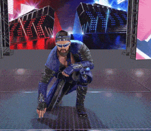 a man in a blue suit and sunglasses kneeling down