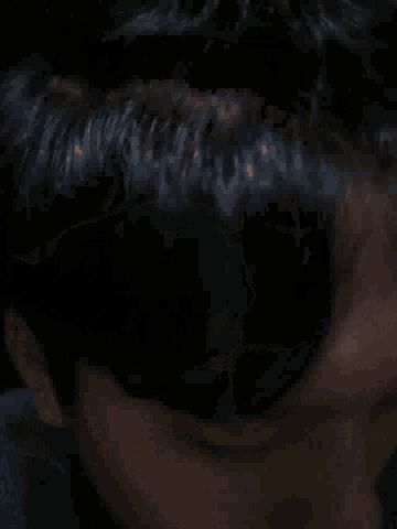 a close up of a person 's face with a black background