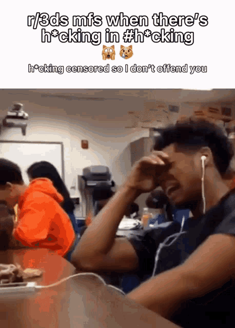 a man with ear buds is crying in a classroom