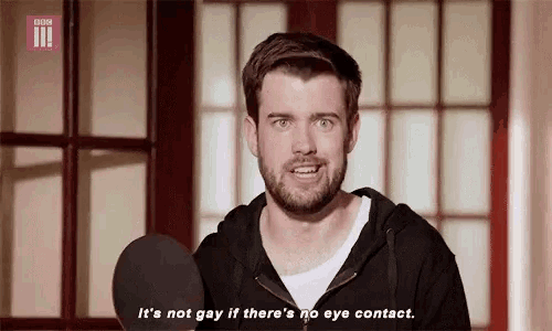 a man speaking into a microphone with the words it 's not gay if there 's no eye contact below him
