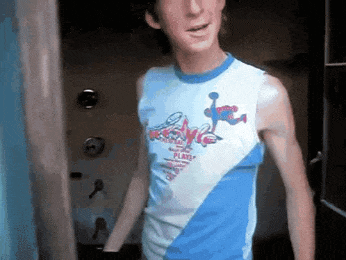 a man wearing a blue and white tank top that says " play "