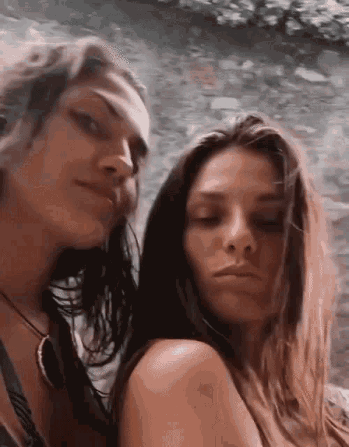 two women with long hair are posing for a picture .