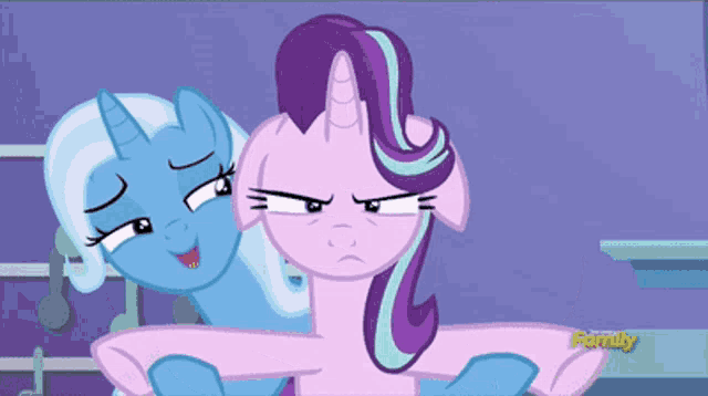 a couple of ponies are standing next to each other with the word family on the bottom right