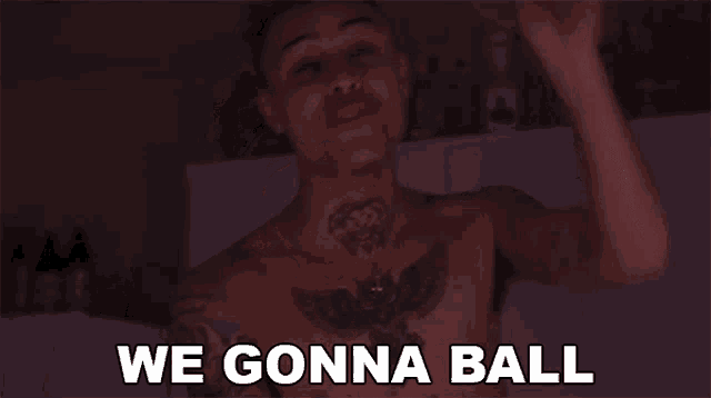 a shirtless man with a tattoo on his chest says " we gonna ball "