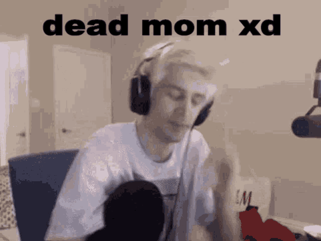 a man wearing headphones is sitting in front of a microphone with the words dead mom xd above him
