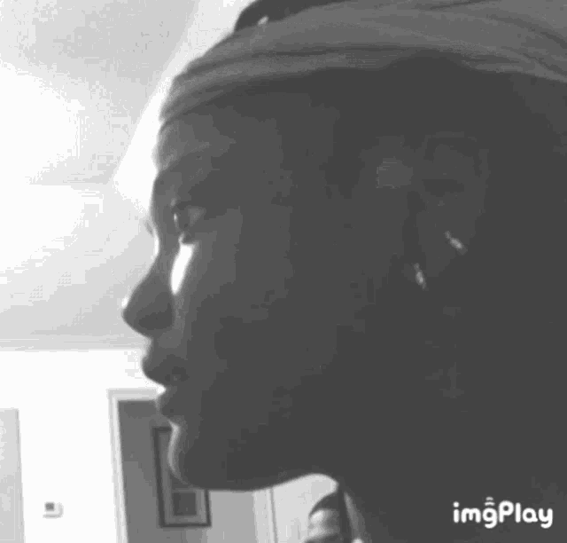 a black and white photo of a woman 's face with the words imgplay below it .