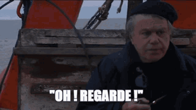 a man sitting on a boat says " oh regarde "