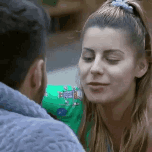 a man and a woman are looking at each other with their eyes closed .