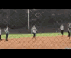 a blurry picture of a group of people playing baseball on a field .