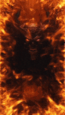 a devil with horns and red eyes is surrounded by fire .