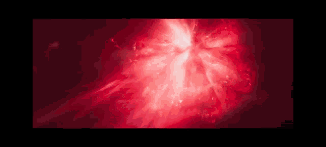 a close up of a red light coming out of a hole in the ground