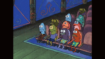 a group of cartoon fish are sitting in a row in a theater