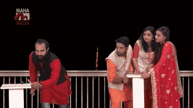 a group of people are standing in front of a maha mazza logo