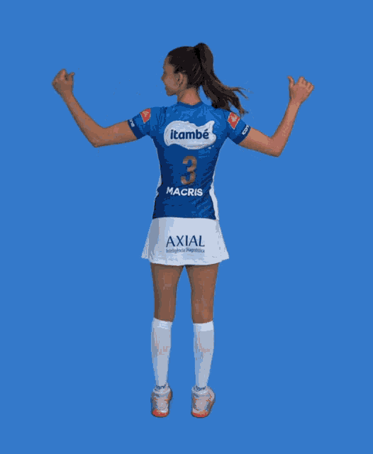 a woman wearing a blue and white itambé macris jersey