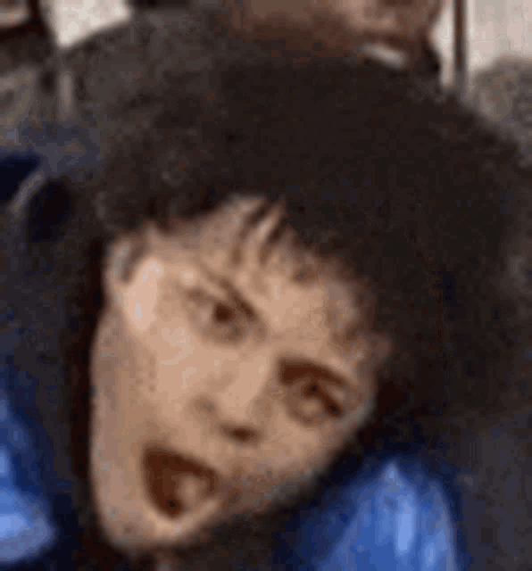 a close up of a person 's face with a surprised look on it .