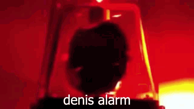 a close up of a red alarm with the words denis alarm on it .