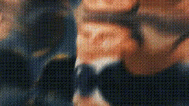 a blurry picture of a man in a suit and tie is being displayed .
