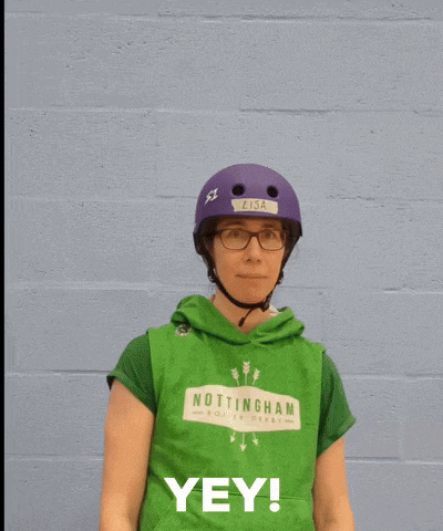 a person wearing a purple helmet and a green shirt with the word yey on it