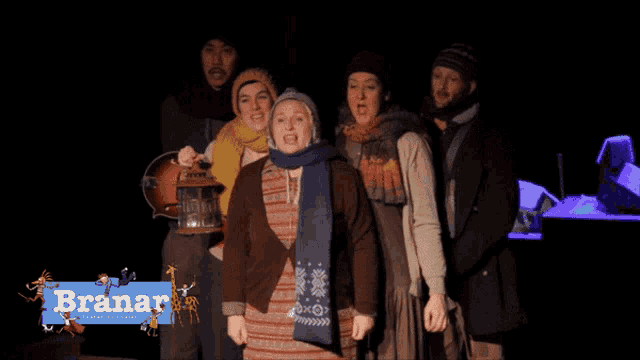 a group of people are singing in front of a banner that says branar
