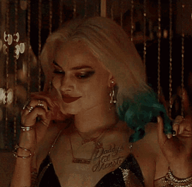 a woman with a tattoo that says daddy 's little monster