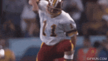 a football player with the number 13 on his jersey is kicking the ball