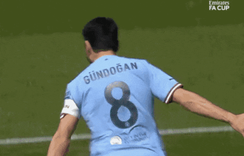 a soccer player with the number 8 on the back of his shirt