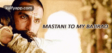 a man with a beard is hugging a woman with the words mastani to my bajirao written on the bottom