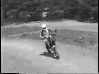 a person is riding a dirt bike on a dirt road .