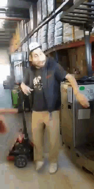 a man in a mask is dancing in a warehouse