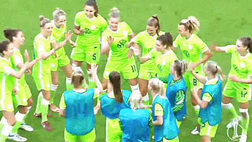 a group of female soccer players wearing green uniforms with the number 5 on the front