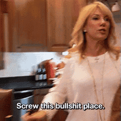 a woman is standing in a kitchen and says screw this bullshit place