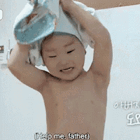 a shirtless child is holding a towel over his head and says help me father .