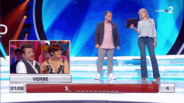 a man and a woman on a stage with the word verbe written on it